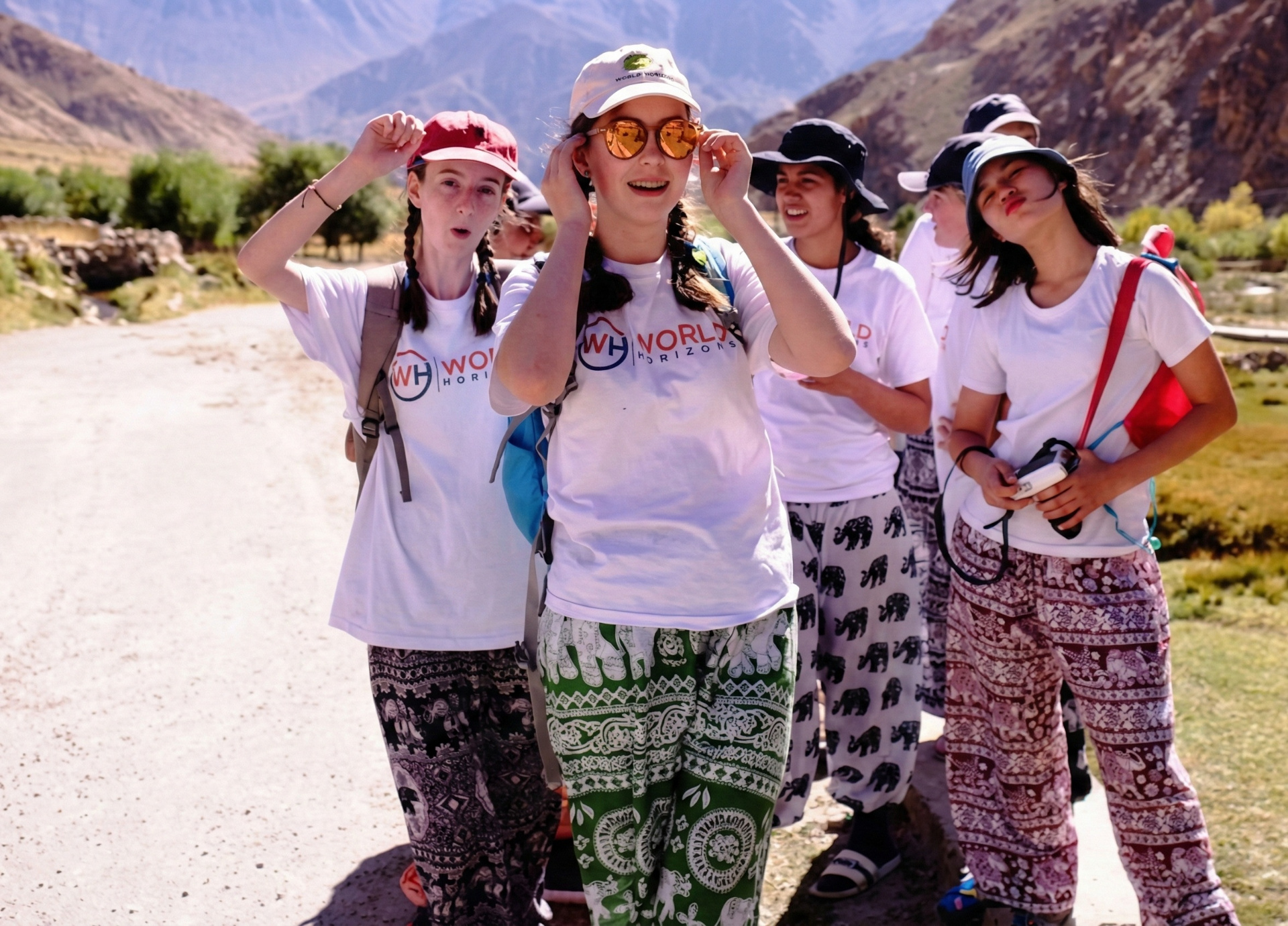 Students wearing World Horizons shirts exploring a mountain village